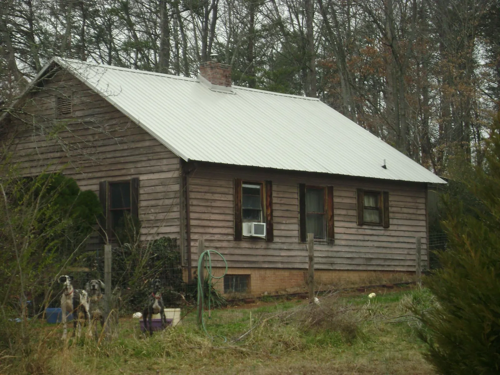 White metal roof on an old wood sided farmhouse, from a Metal Roof Installation job in Tamaqua